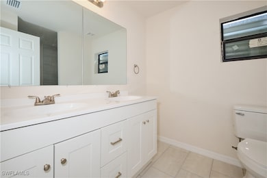 Bathroom featuring vanity, tile patterned floors,