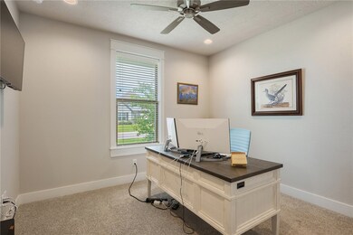 Office space with ceiling fan, carpet, and baseboa