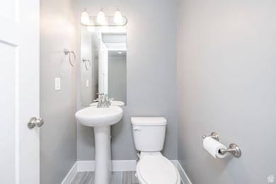 Bathroom with toilet and baseboards