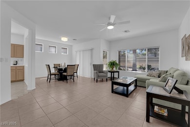 Living room with light tile patterned floors and a