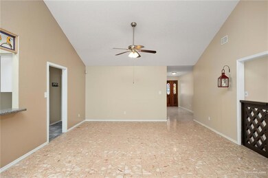 Spare room with light tile flooring, ceiling fan, and high vaulted ceiling