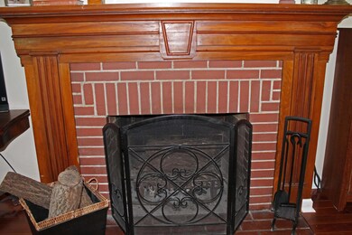 Original wood mantel with carved detail