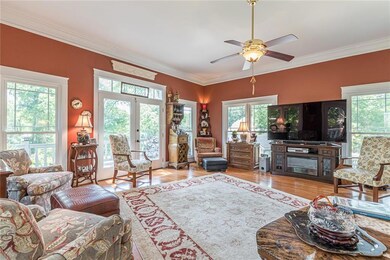 Living area with a ceiling fan, french doors, crow