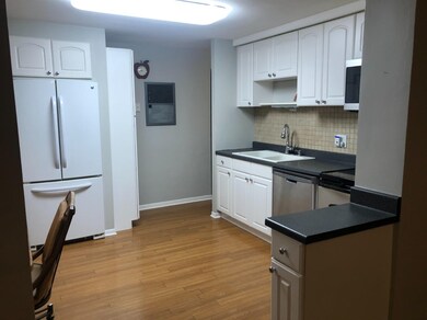 Tiled backsplash and vinyl plank floors in kitchen