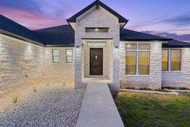 Entrance to property with stone siding and roof w