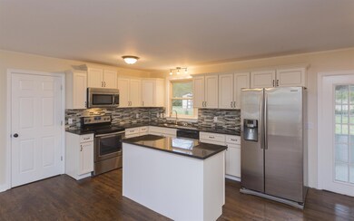 Complete with backsplash, brand new stainless steel appliances, cabinets, and granite.