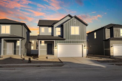 View of front facade with board and batten siding, driveway, an attached garage, and a shingled roof