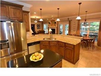 NOTICE THE LARGE WORK ISLAND, AND TILE THAT FLOWS 