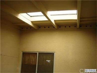 Side patio by front door with large patio skylight