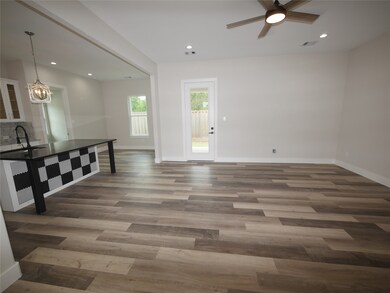 BIG OPEN LIVING ROOM WITH VIEW OF KITCHEN AND DINI