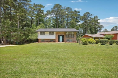 Bi-level home with a front lawn and brick siding