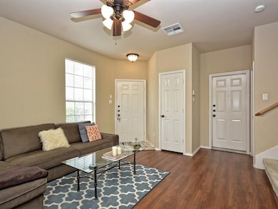 Living room with dark wood finished floors, baseb