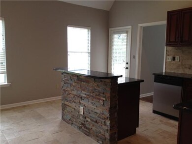 kitchen island with granite and tile wrap around