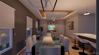 Dining area with baseboards, light wood-style flooring, and a raised ceiling