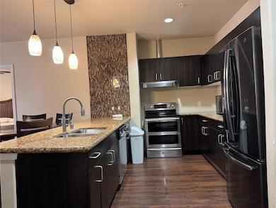 Kitchen with dark wood finished floors, appliances
