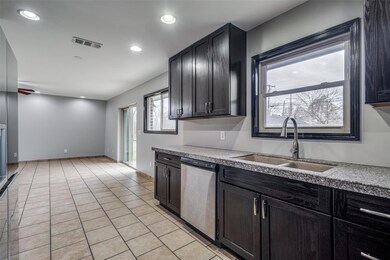 Kitchen with stainless steel dishwasher, light til