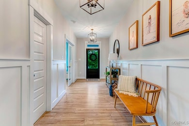 Foyer with a chandelier, a decorative wall, and a