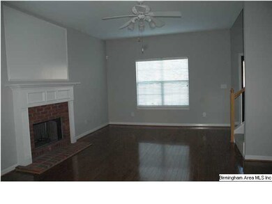 Greatroom with hardwood floors and brick, wood-bur