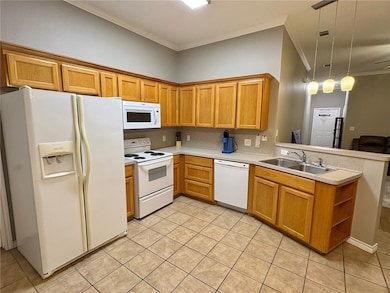 Kitchen with white appliances, ornamental molding,