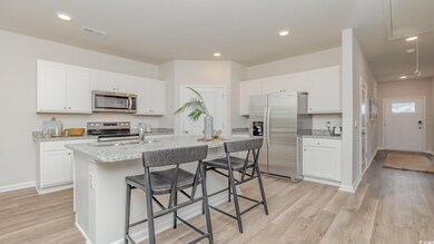 Kitchen featuring white cabinets, sink, a center i