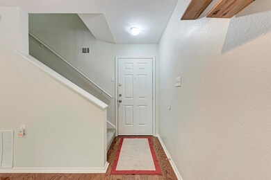 Doorway with baseboards, stairs, wood finished fl