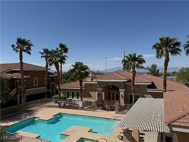 Community pool featuring a patio and fence