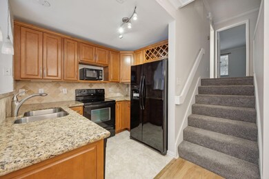 Kitchen with black appliances, crown molding, sink