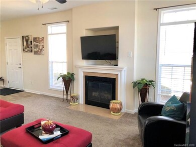 Family room has gas fireplace with marble surround