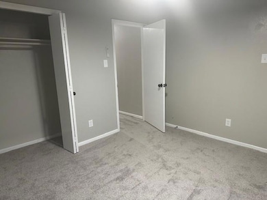 Spare room with a textured ceiling, vaulted ceilin
