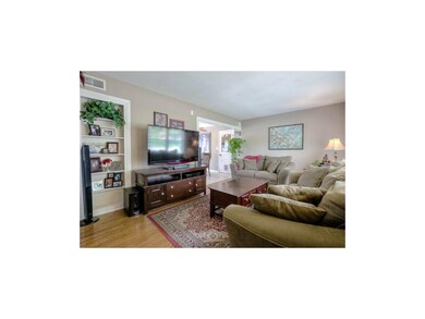 COMFORTABLE LIVING ROOM WITH LOVELY HARDWOODS.
