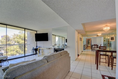 Living area with a textured ceiling, a notable cha
