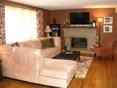 Living Room. Shiny hardwood floors and gas log fir