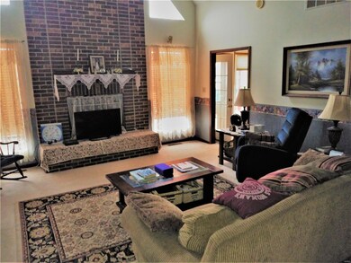 Family room with floor to ceiling brick fireplace