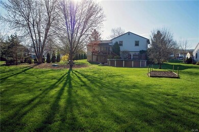 Large backyard with mature trees, pool and garden.