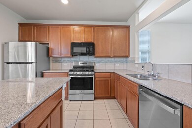 Kitchen with stainless steel appliances, light st