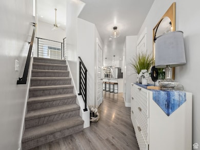 Staircase featuring wood finished floors and baseboards