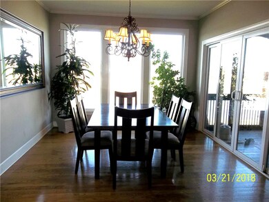 Dining Room with Wood Floors, Large Windows and Sl