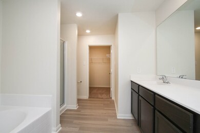 
The private master bathroom offers plenty of storage with a sprawling vanity and linen closet.
