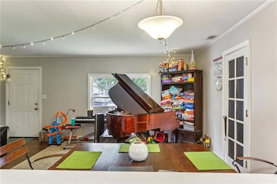 Game room featuring ornamental molding and wood finished floors