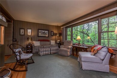 Den with large windows facing back yard.