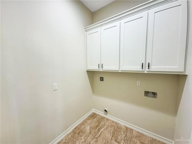 Laundry room featuring cabinet space, washer hookup, and electric dryer hookup