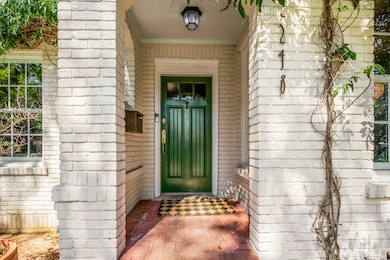 A charming, recently painted green front door offe