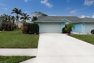 Ranch-style home with a garage and a front lawn