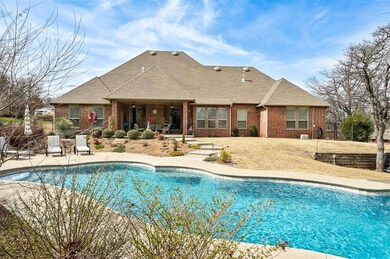 View of front of property featuring stone siding, brick siding, a shingled roof, and a front lawn