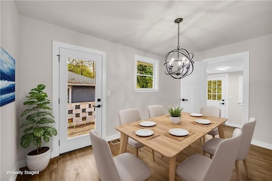 Dining space featuring a chandelier and wood finished floors