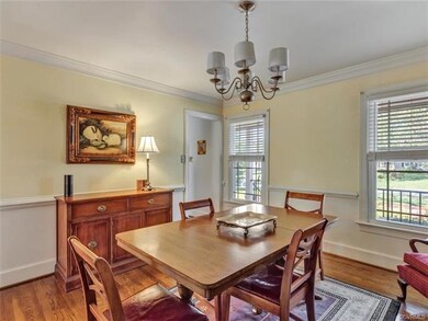 Large dining room - wood floors, crown molding, ch