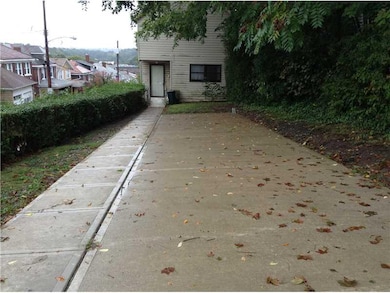 Exterior Front. Concrete parking area in front of 