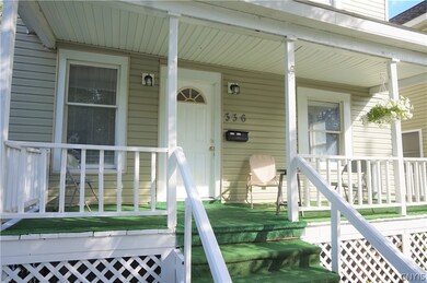 This charming covered front porch greets you as yo