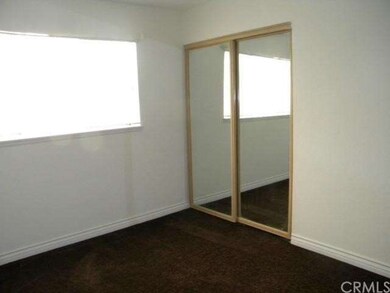 BEDROOM WITH MIRRORED CLOSET AND NEW CARPET.