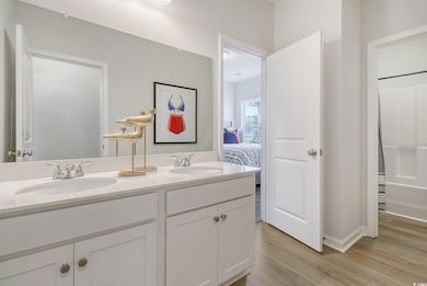 Ensuite bathroom with double vanity, wood finished